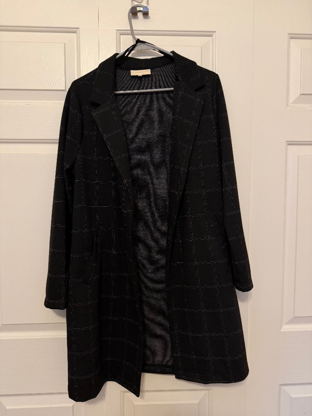 Black coat with white plaid stitching